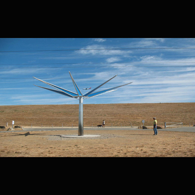 Wind wheel casts prismatic rainbows as it creates a circular gateway for vehicular traffic entering the park. 27’ diameter X 17’ tall .stainless steel, Aluminum prisms.15’ x 27’ x 27’ 2008. Commissioned by the City of San Mateo